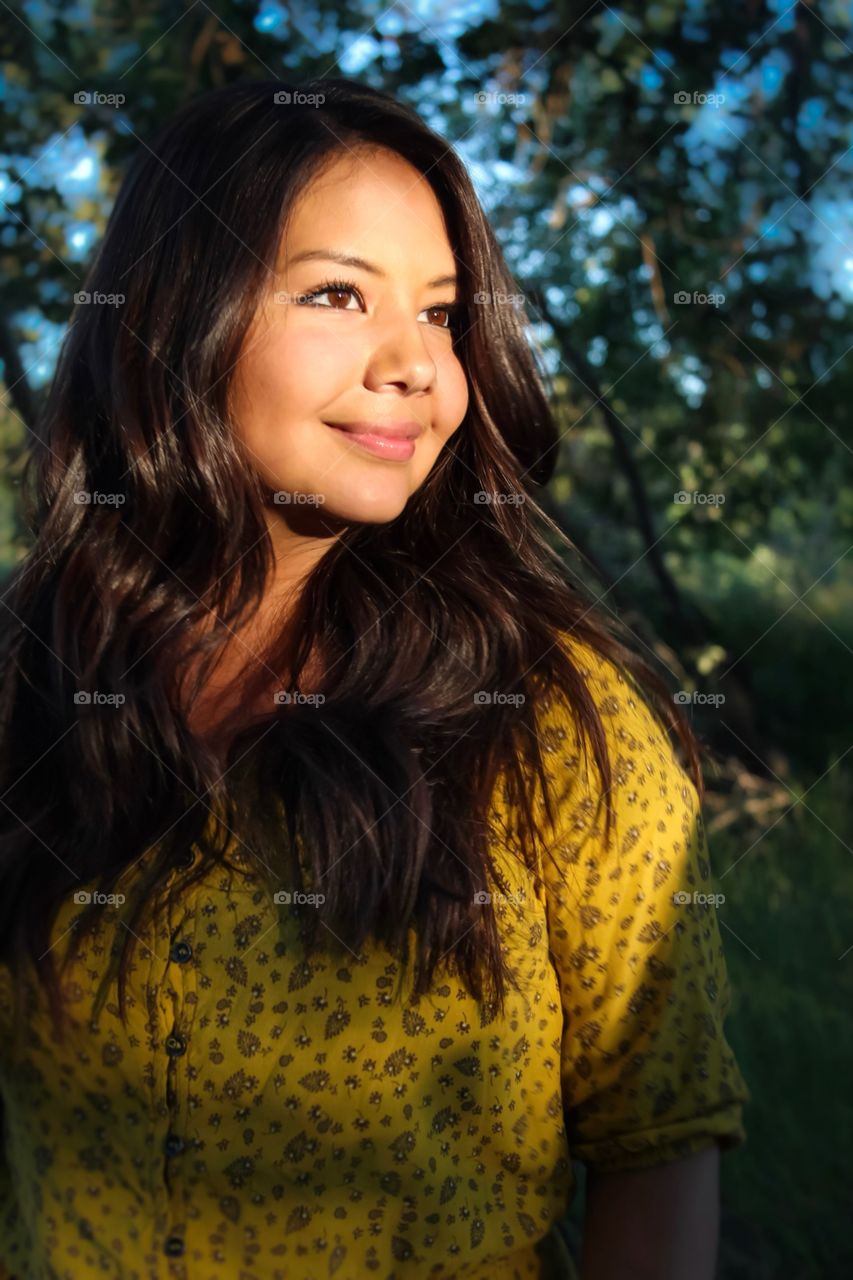 Beautiful brunette in the golden sunset 