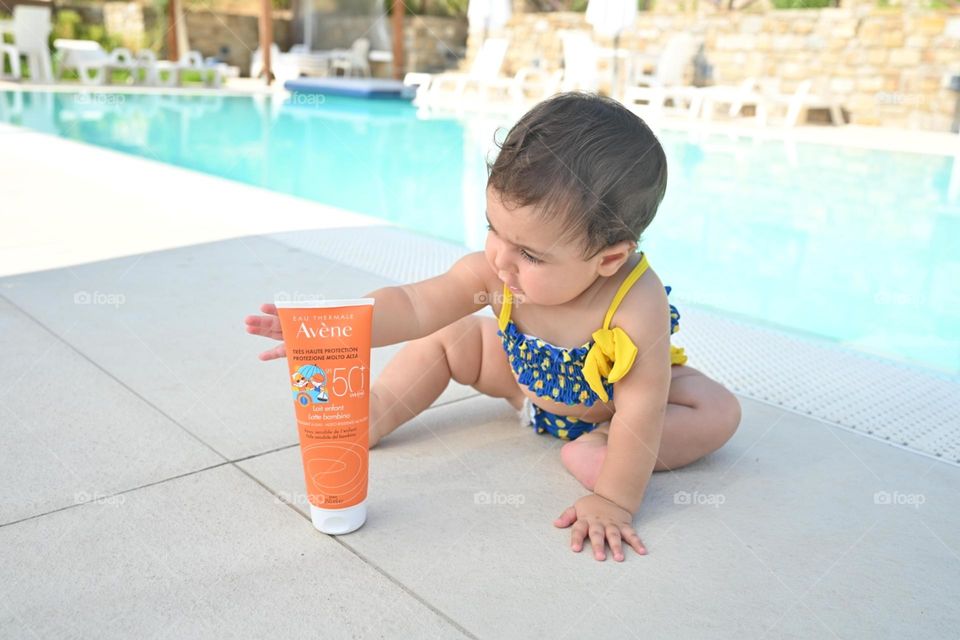 little girl taking Avéne sunscreen