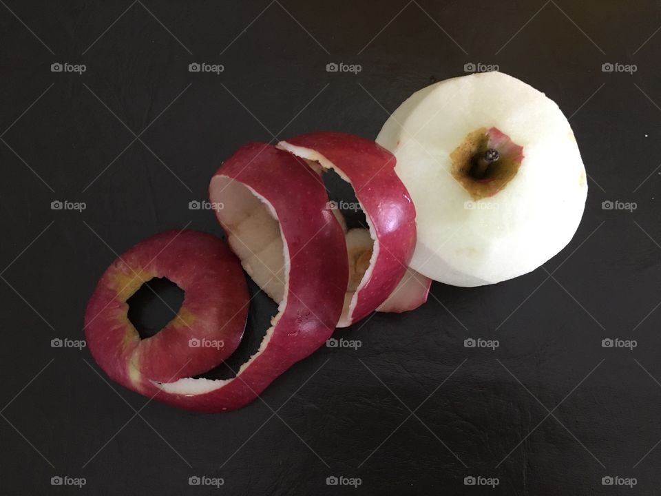 Peeled red apple with peel