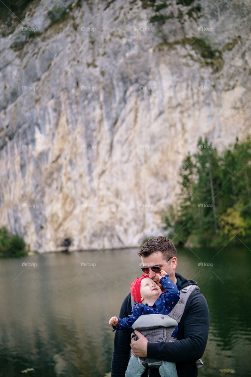 Dad and daughter on a small lake on mountain
