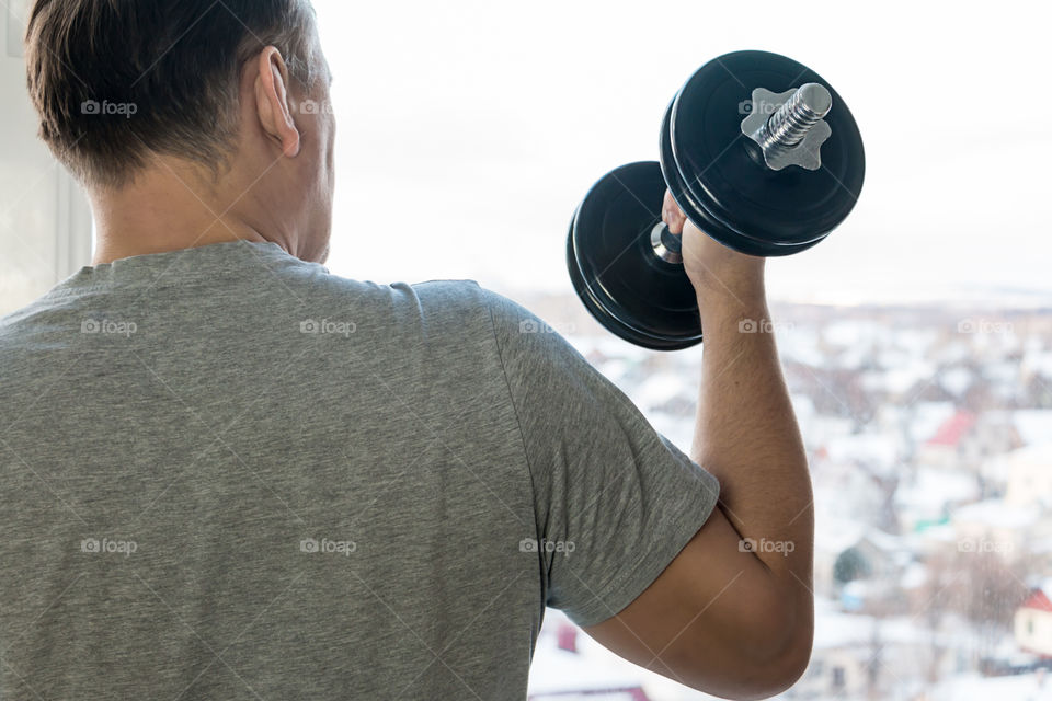 man with dumbbells doing exercises