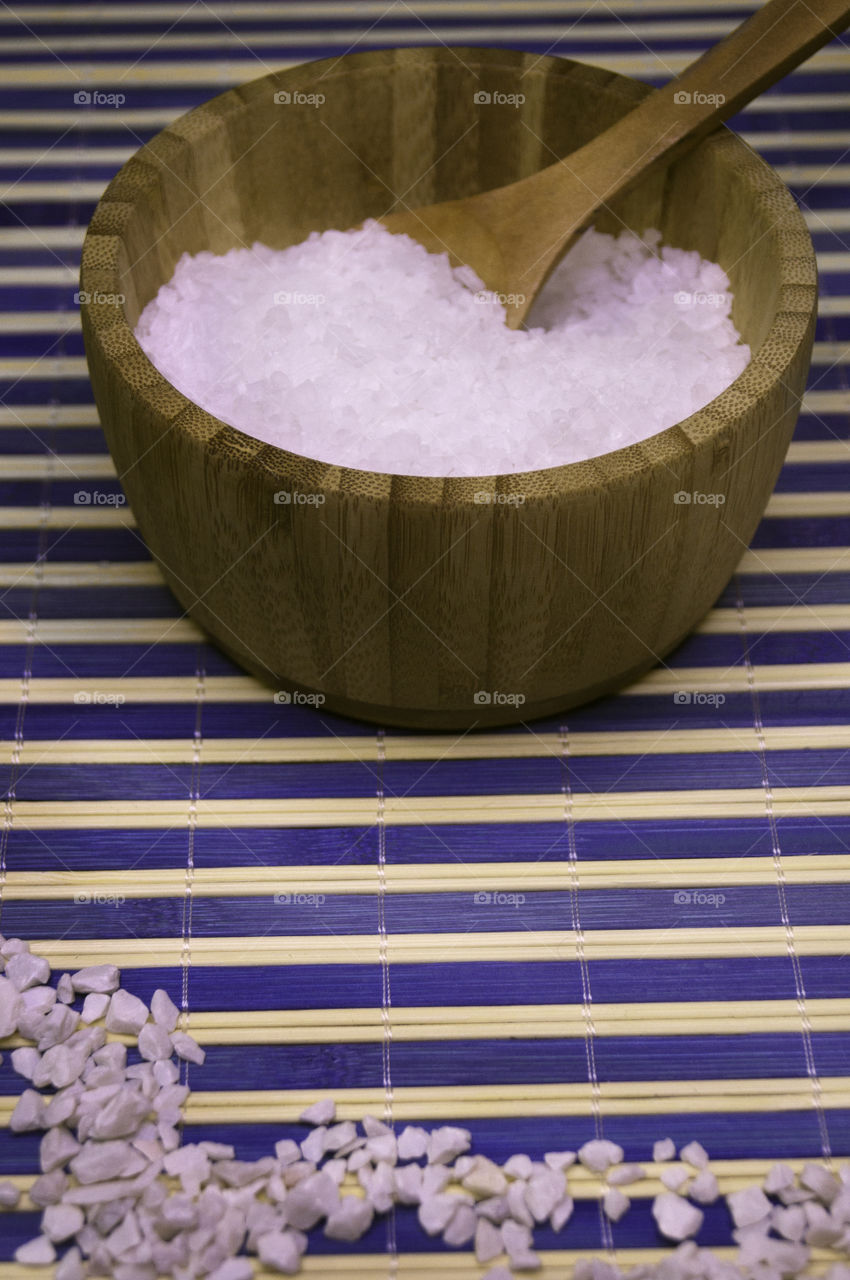 salt in a bamboo bowl with stripes background