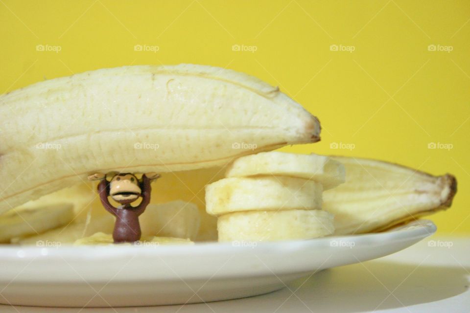 Heavy Meal. A fresh banana and a cute toy monkey