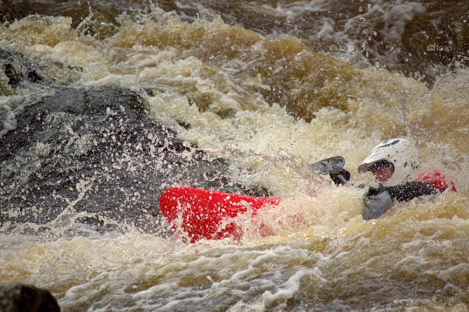 Helsinki, Finland -  April 17, 2016: Unidentified racer at the annual iceBREAK whitewater kayaking competition at the Vanhankaupunginkoski rapids in Helsinki, Finland. 