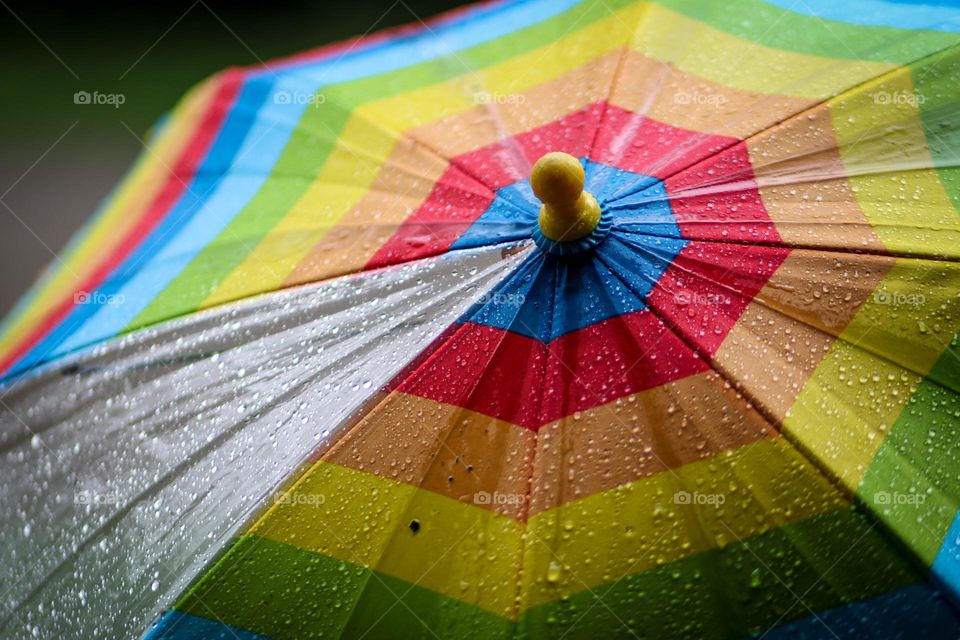 Rain drops on a colorful umbrella