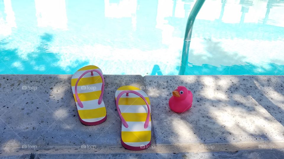 Flip flops and a pink duck