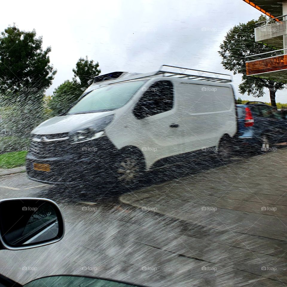 car drives through puddle.
