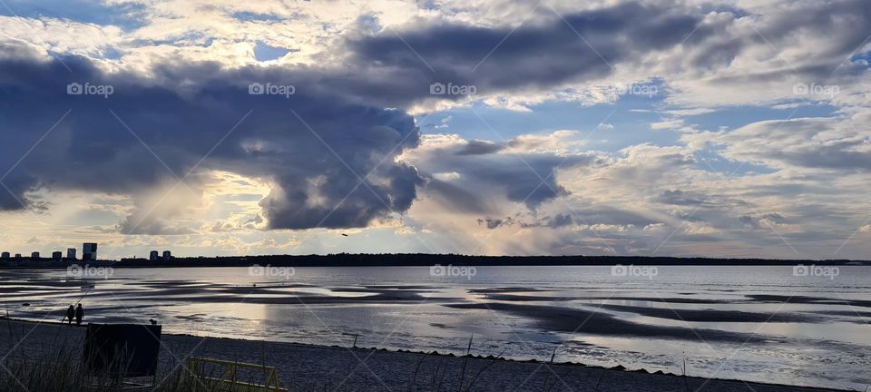 Sunset on the sea, dark clouds