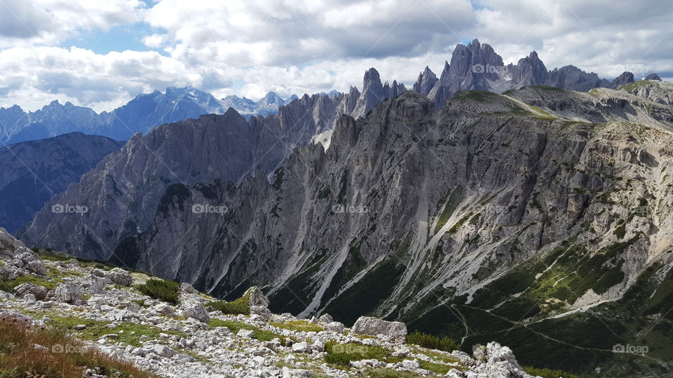 Hiking trail at high altitude in the mountains, high mountain peaks and clouds 