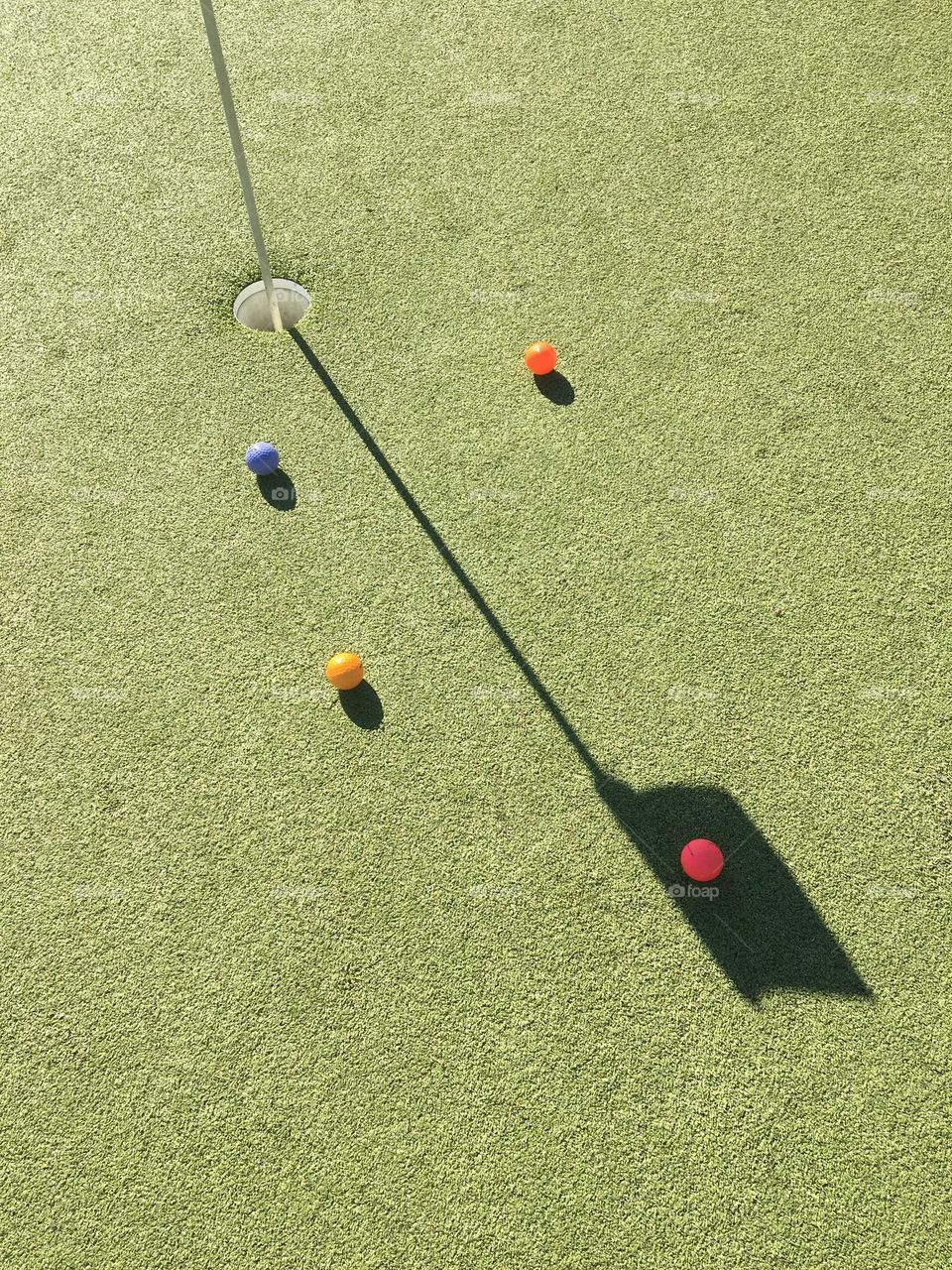 Shadow of the flag on a golf green