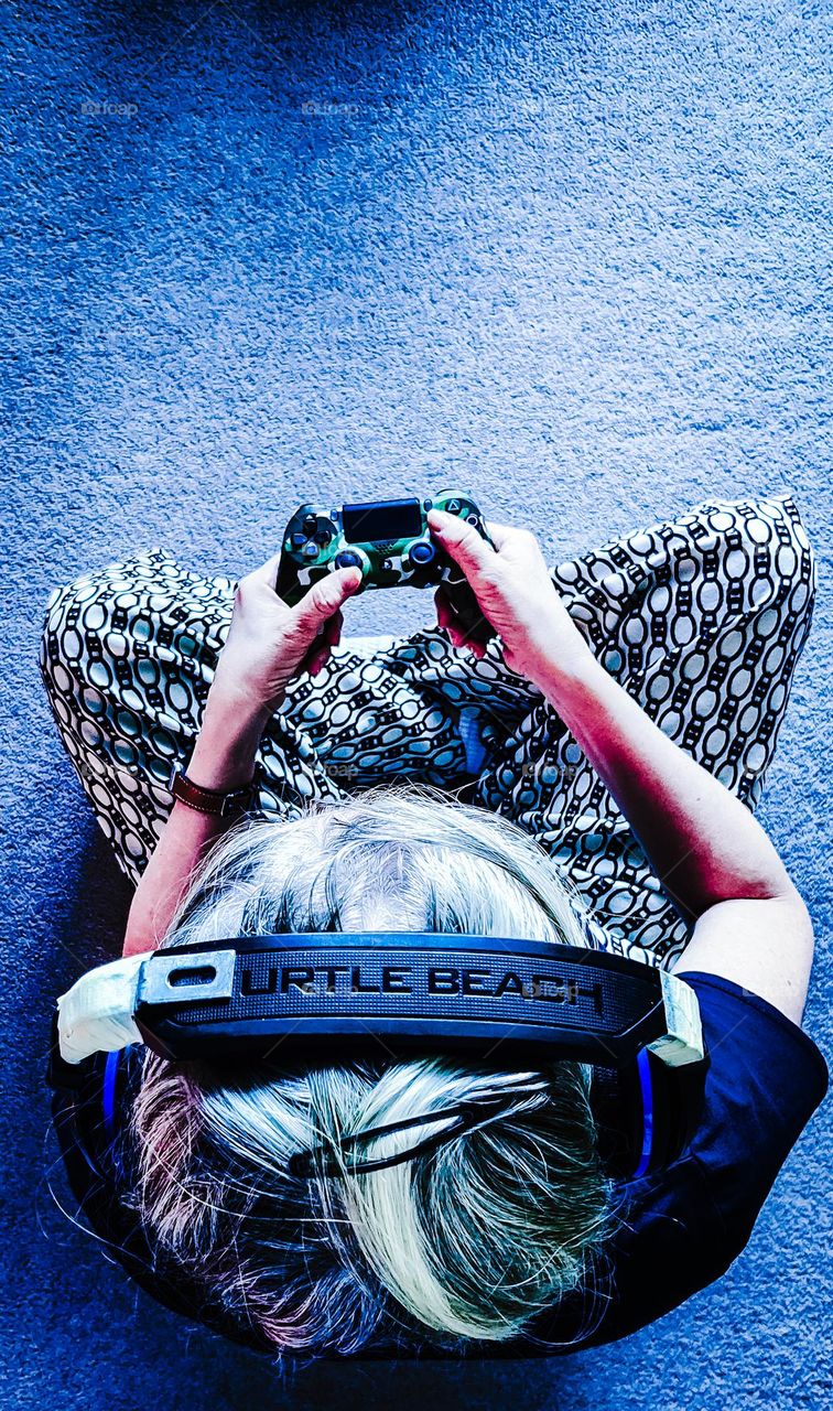 Blonde woman playing video games.