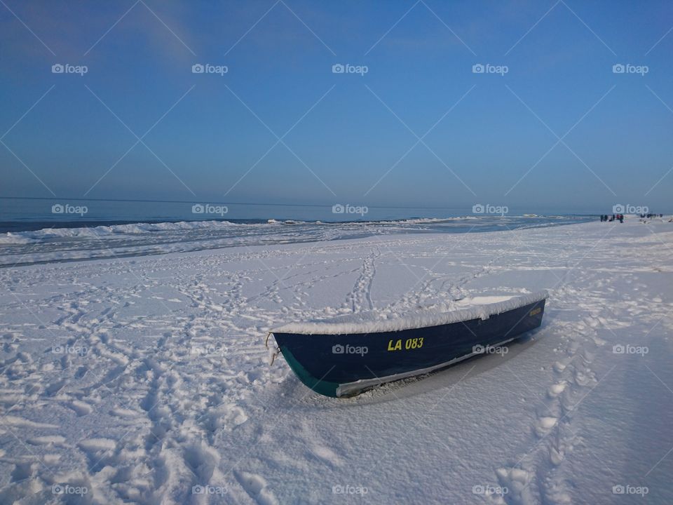 boat on the seafront in snowy winter