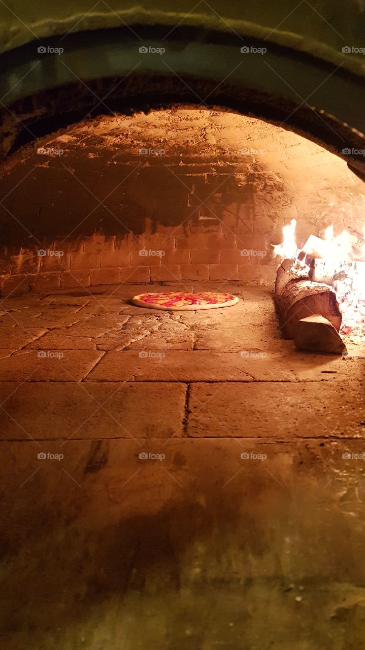 Wood oven with a pizza