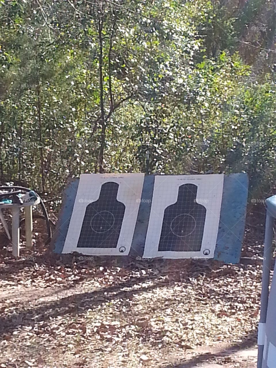 Two figures on target paper set up for target practice.