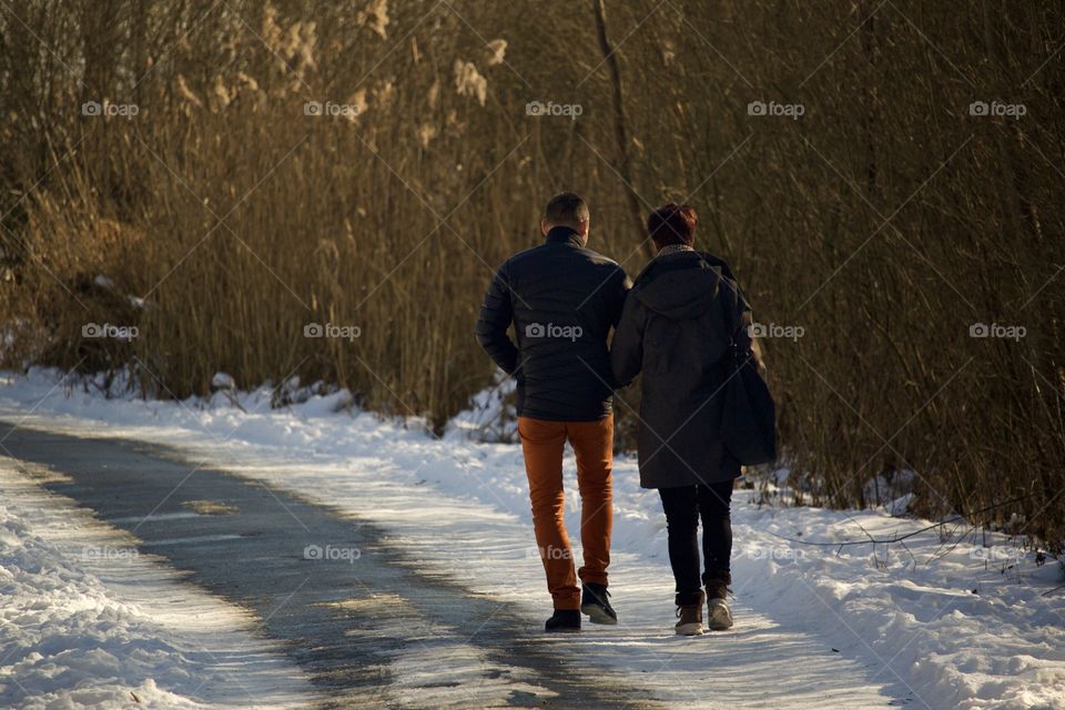 Couple Walking Around The Lake