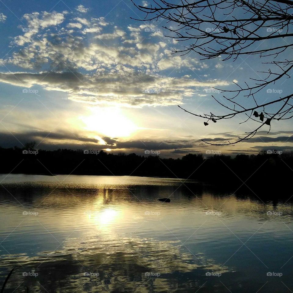 Cloudy sky reflecting on lake
