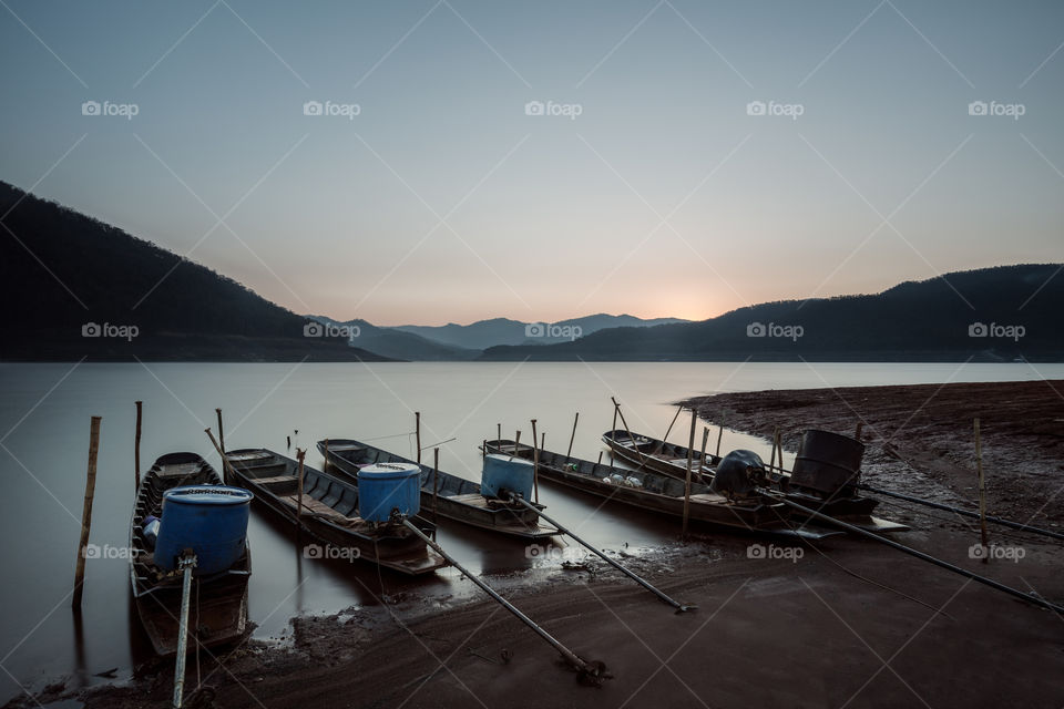 Boat docking in the river at dusk