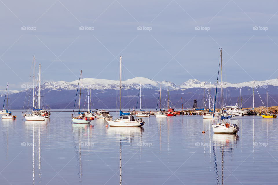 landscape with boats and snowy mountains