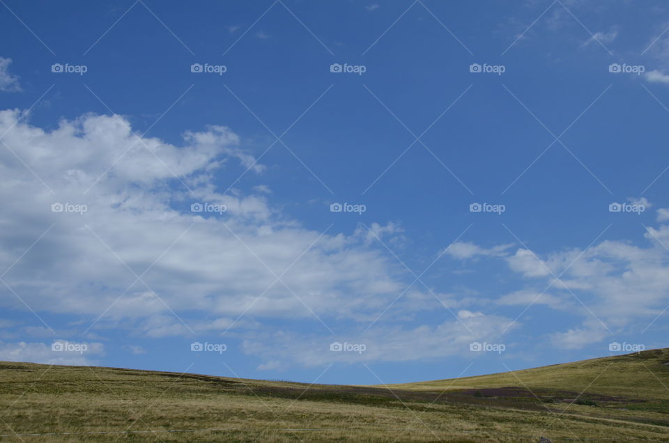 this photo represents the top of a mountain which is the balloon of Alsace in France, we see the shadow of the cloud above