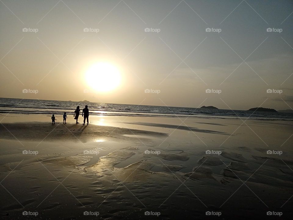 Family with children on beach enjoying beautiful sunset in Holliday time nice view of the nature beautiful background sky clouds water it's looking amazing