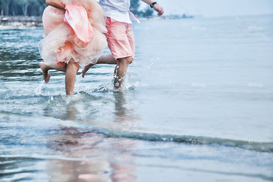 Couple running in water