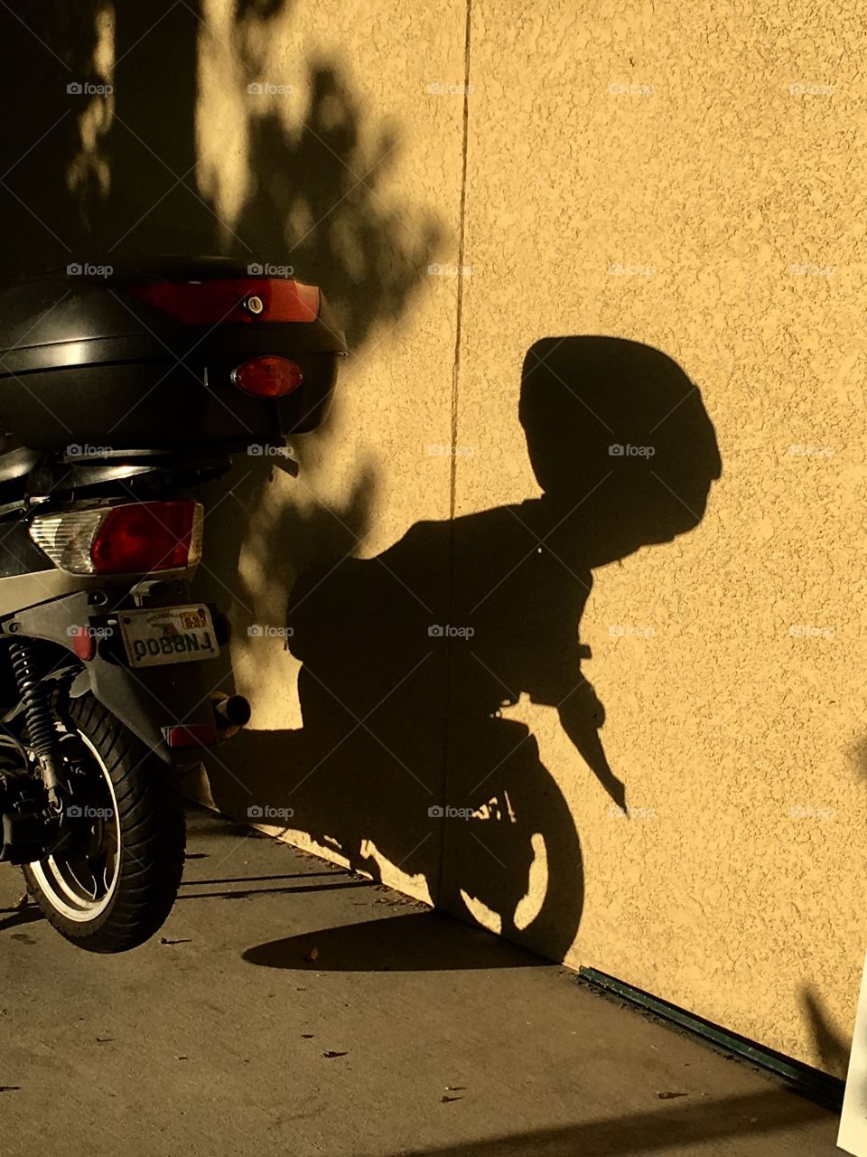 Alien looking shadow silhouette from a moped
