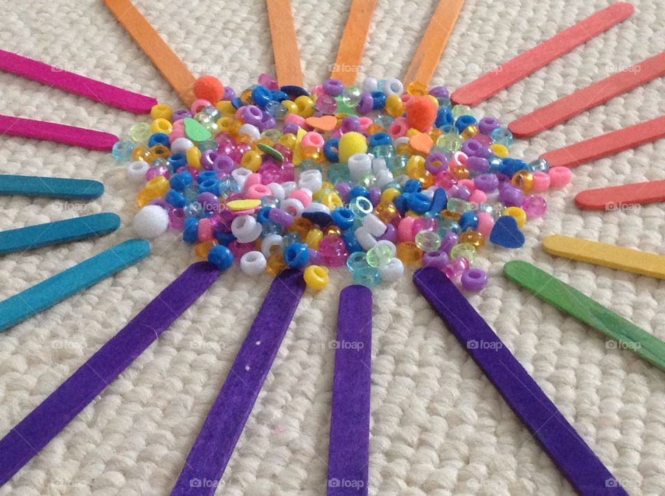 Popcicle sticks and beads for arts and crafts supplies.