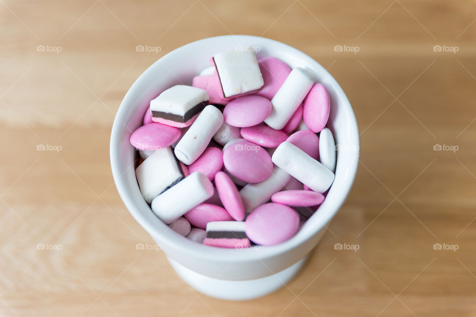 White and pink candy in a white bowl 