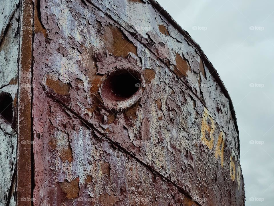 Old rusty boat stranded at the beach