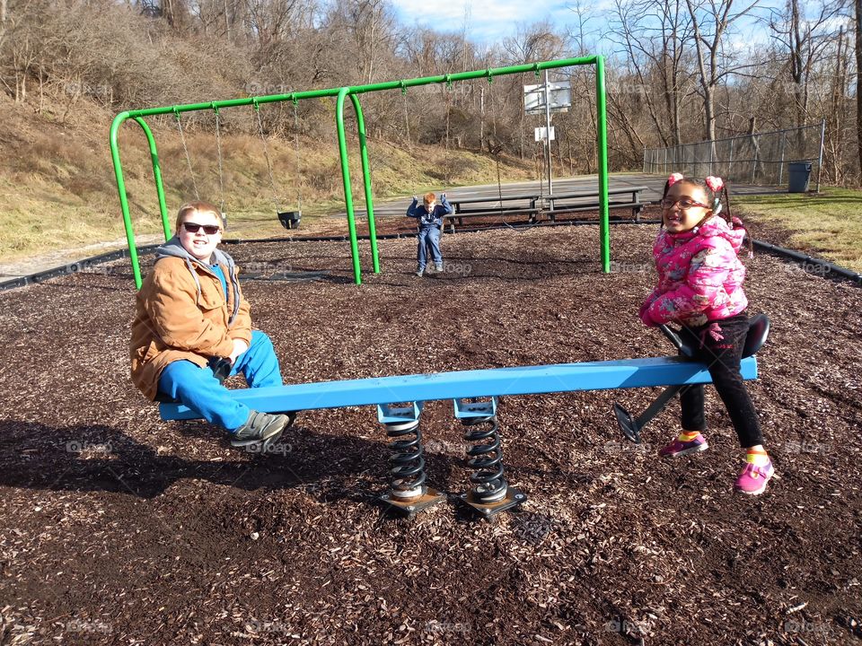 playground boy and girl teeter totter