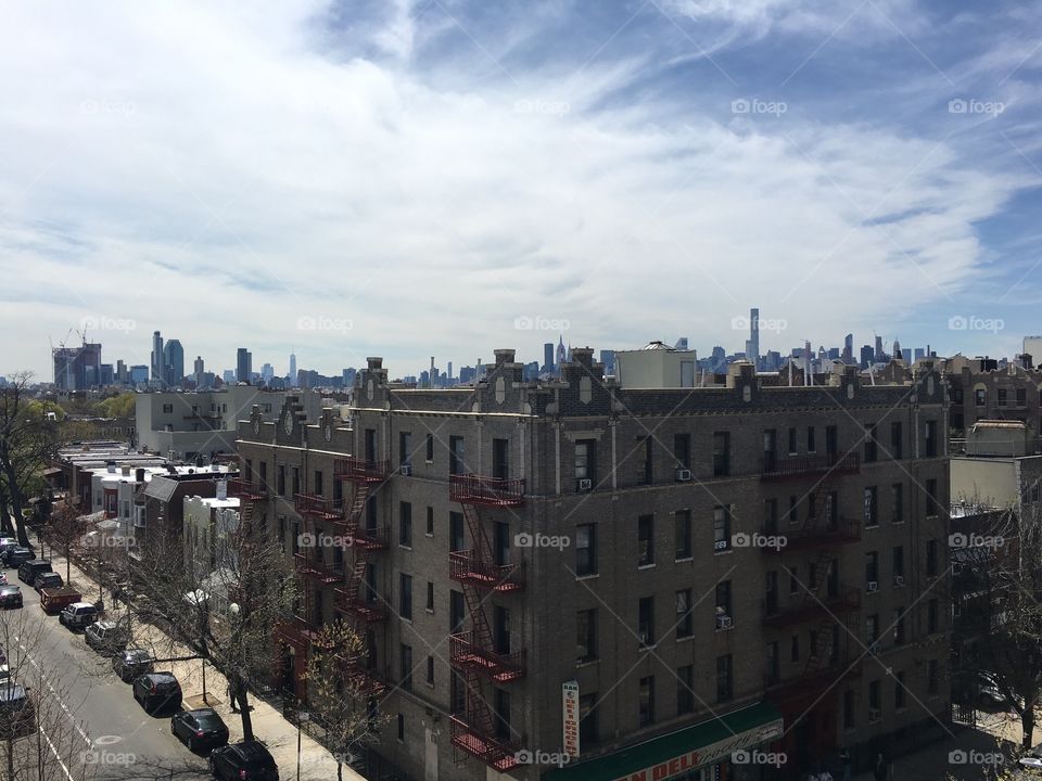 View of historic urban neighborhood and high rise buildings in the background during early spring