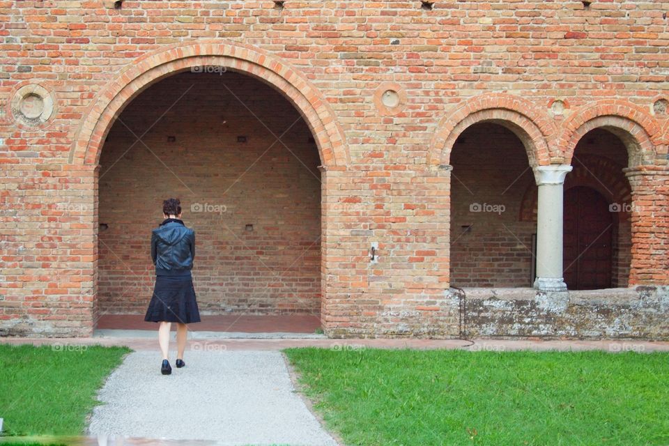 woman walking towards old church