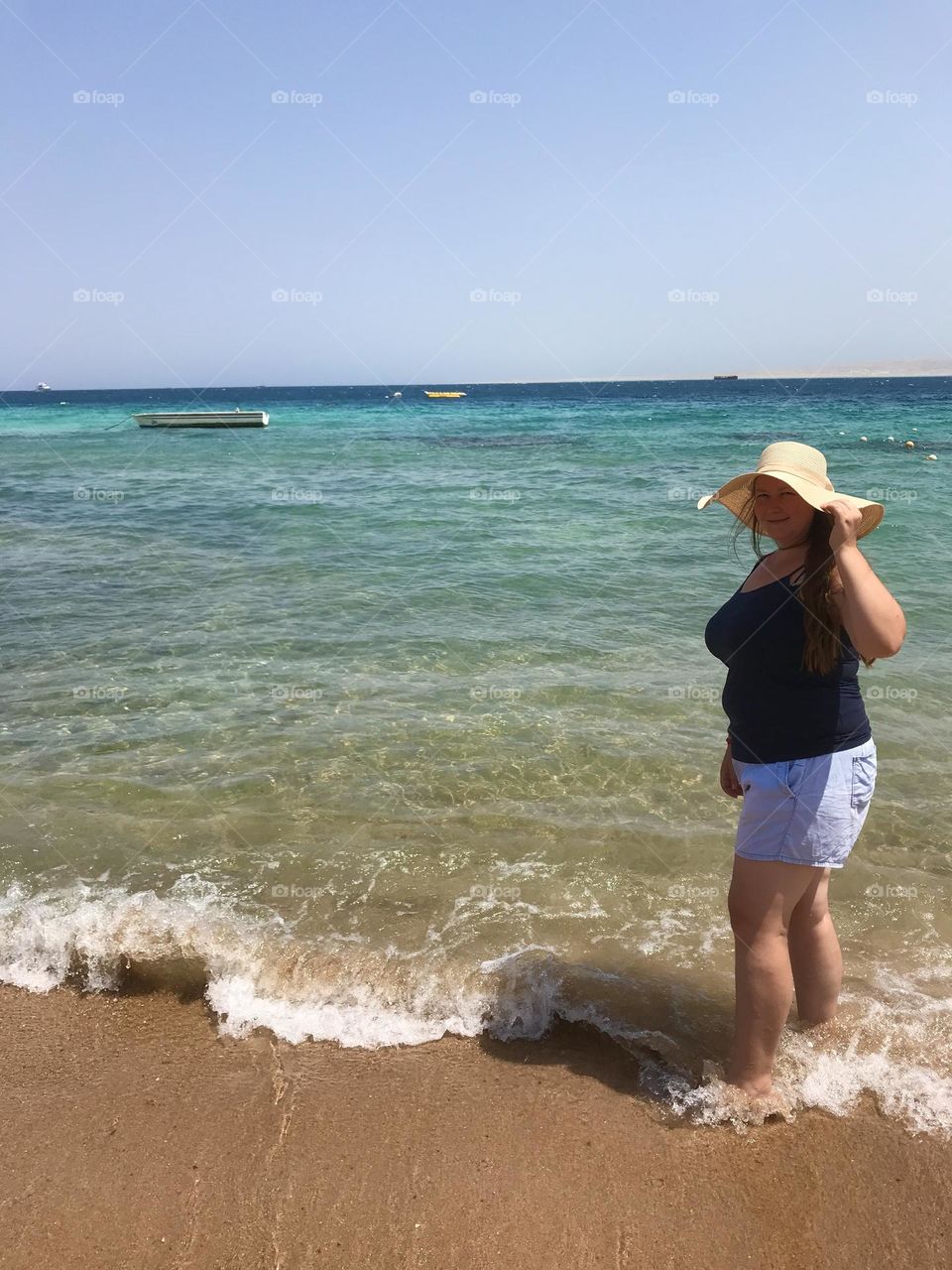 A girl going into the blue sea