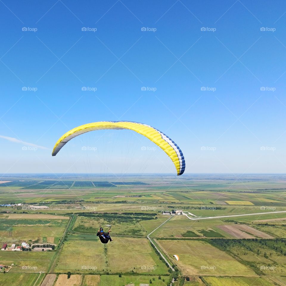paraglider against the clear blue sky