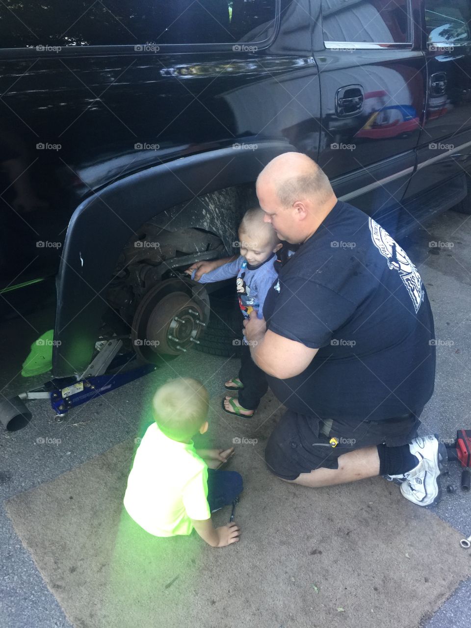 Working on cars with toddlers