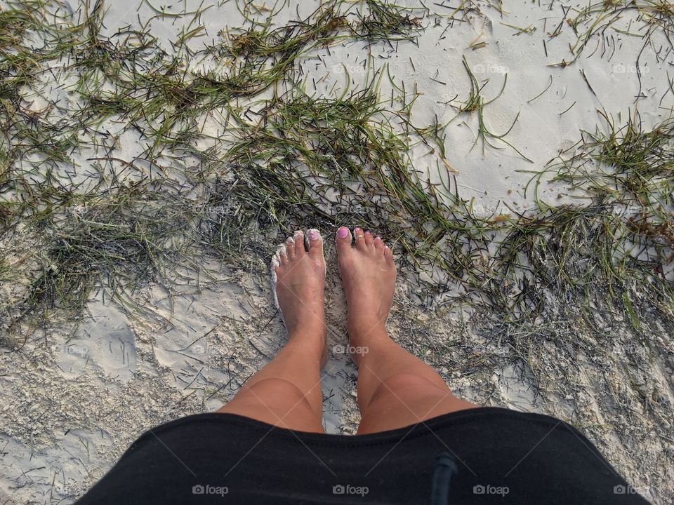Standing in seaweed.