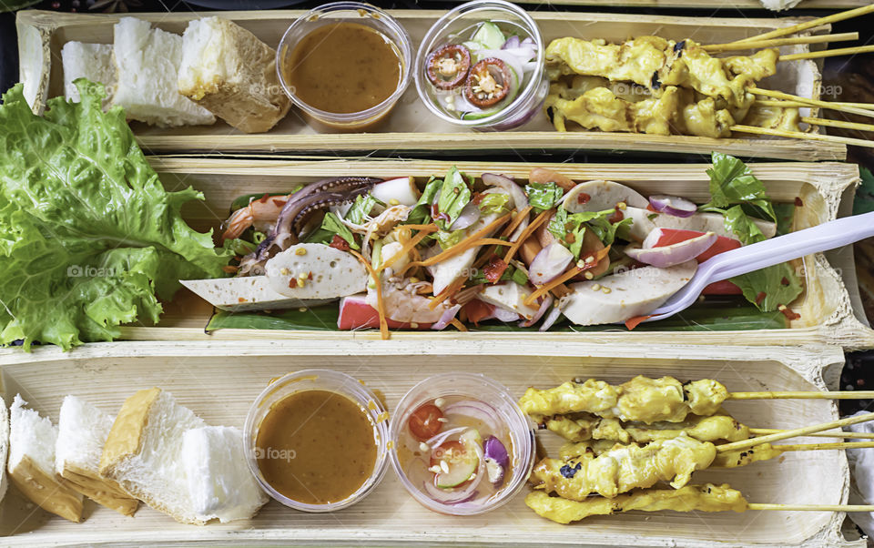 Pork Satay with coconut milk  and Spicy shrimp with vegetables in bamboo.