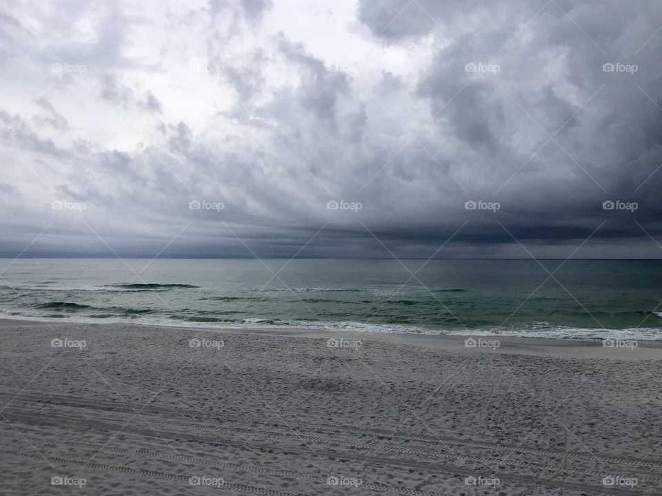 Storm clouds rolling in at empty beach 