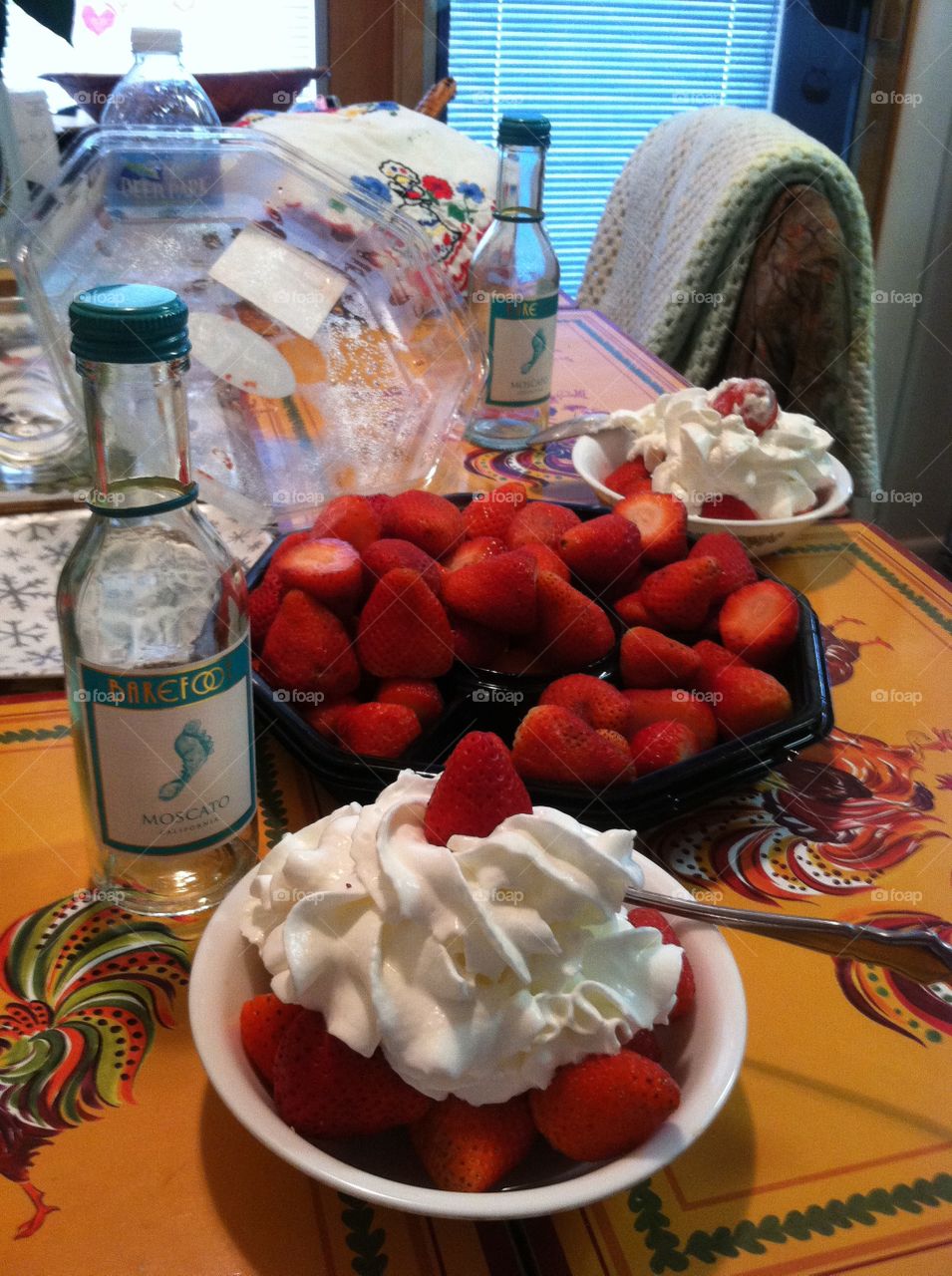 Strawberry with whipped cream topping . Delicious Dessert in the kitchen 