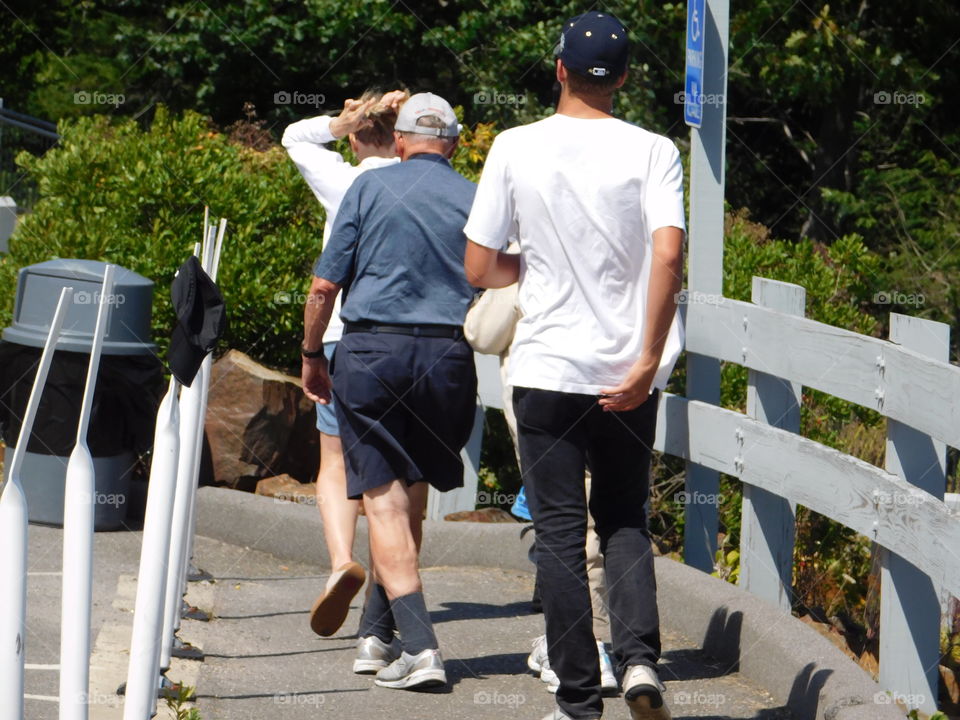 An elderly couple holding on 