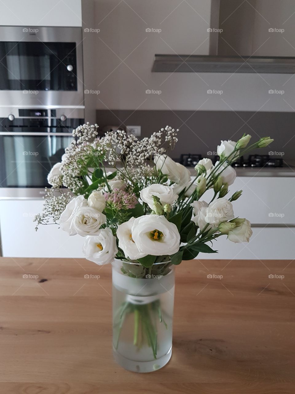 Fresh white flowers in a vase on dining table