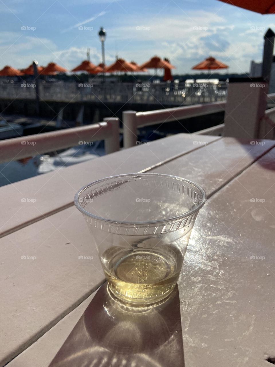 A glass, or rather, cup of white wine, enjoyed by the water at the 9th Avenue Pier bar and restaurant in Belmar, NJ. It’s a plastic cup 3/4 empty. Refill please!
