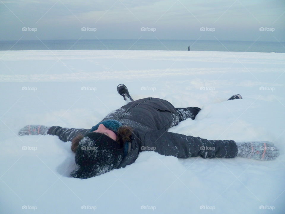 Lying on a snowy beach in Gdańsk