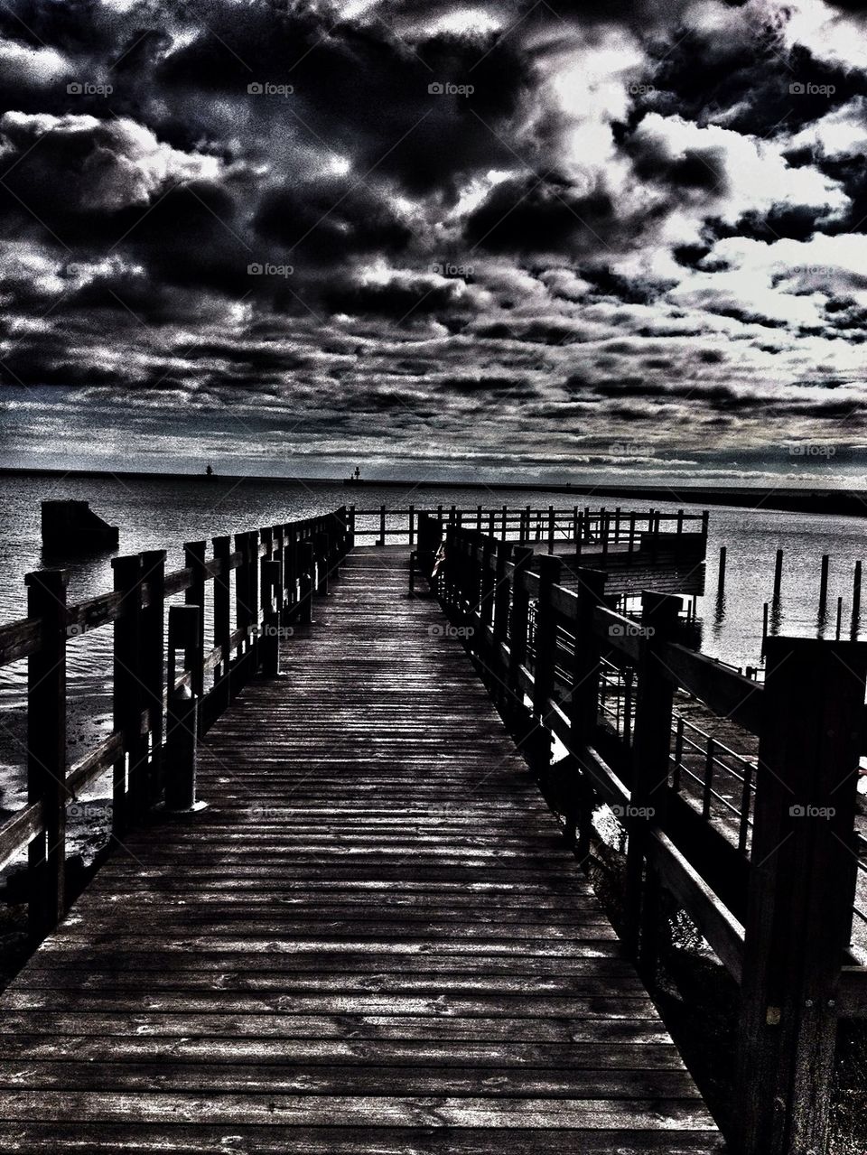 Black and white wharf into the sea