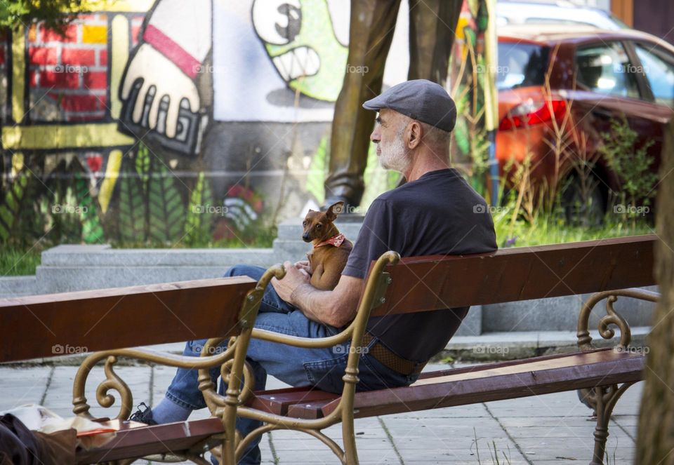 A man and his dog on the bench