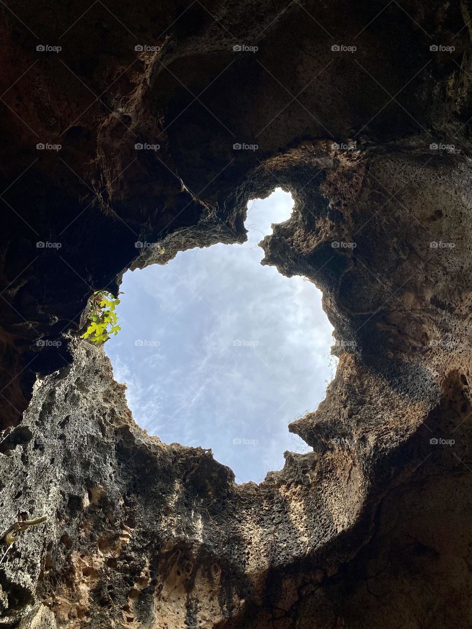 Looking at the sky thru a hole in the roof of a cave 