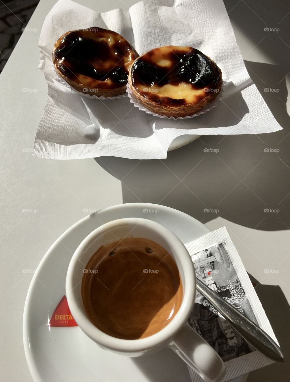Morning coffee and pastel de nata with sun