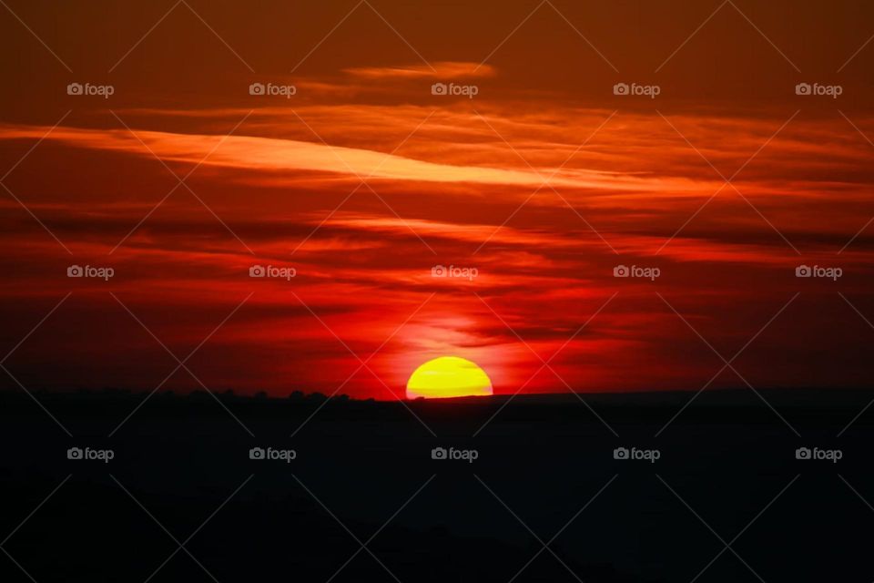 Painting in the sky. Hues of reds, yellow and orange clouds . Yellow clouds, red clouds. Gorgeous view