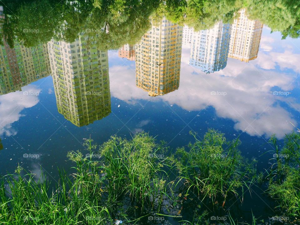 reflection of buildings in the lake