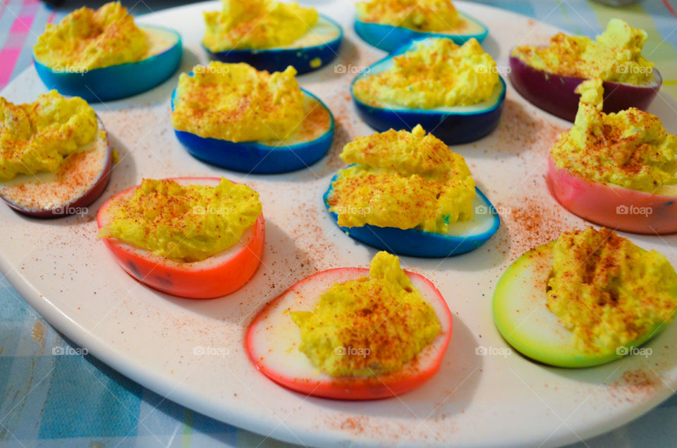 Boiled eggs peeled then dyed and made into deviled eggs for Easter